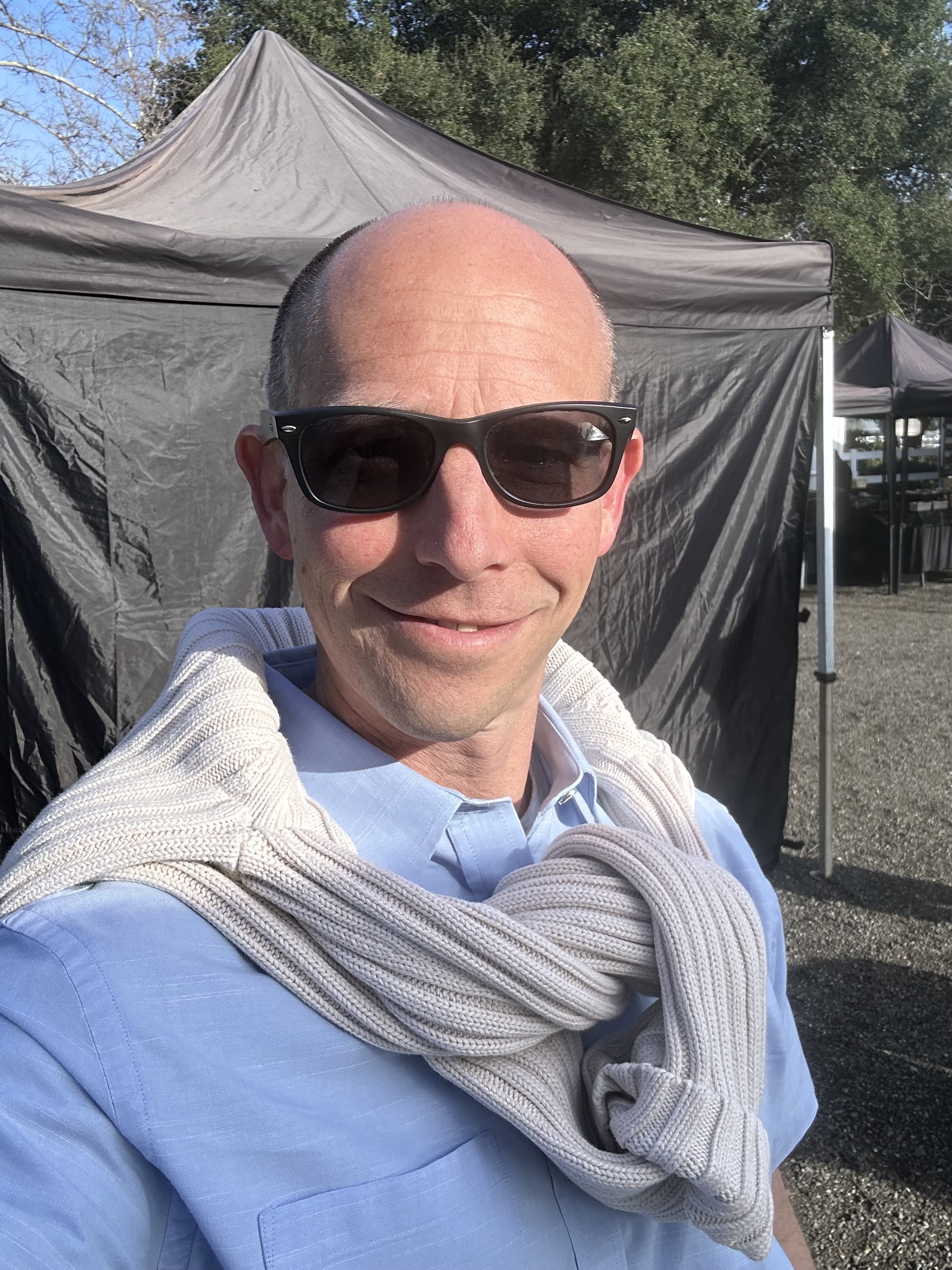 Randy Loveridge in sunglasses and a blue shirt between takes